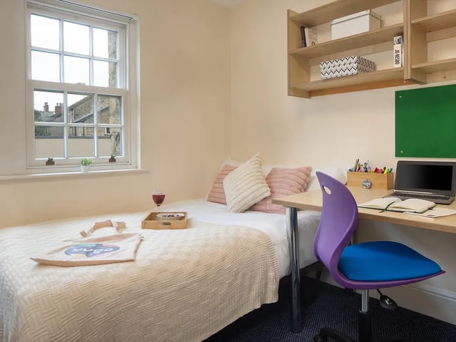 Bed desk chair laptop and bookshelves bedroom at Cable Street Lancaster in Lancaster Student Accommodation