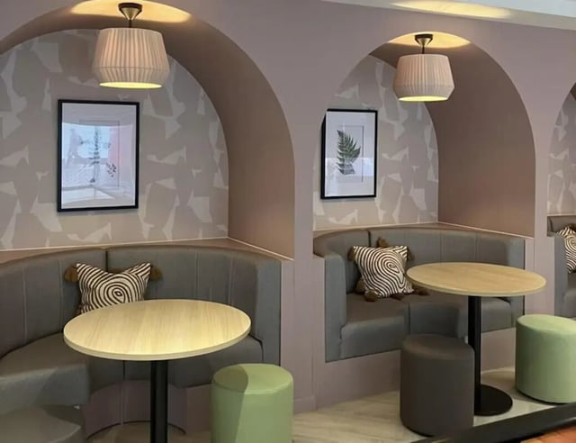 Booth seating tables with artwork and lamps common area at Byrom Point in Liverpool Student Accommodation