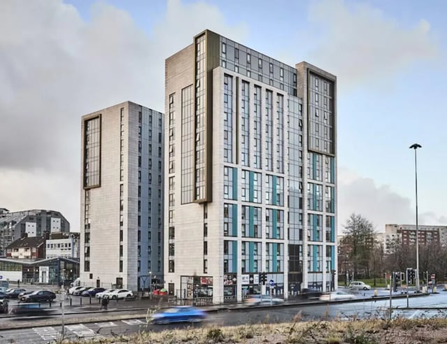 Modern student accommodation towers with cars and street Exterior at Byrom Point in Liverpool Student Accommodation