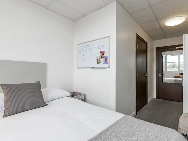 Bed whiteboard doors and doorway bedroom at MyPad Paisley in Paisley Student Accommodation