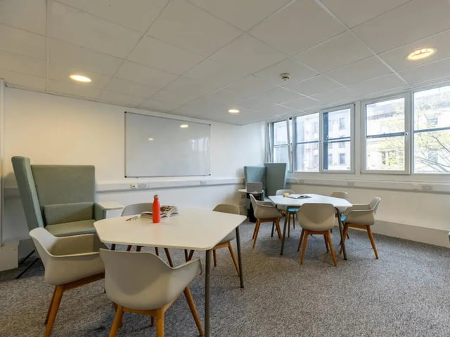 Study area with tables chairs and whiteboard common area at MyPad Paisley in Paisley Student Accommodation