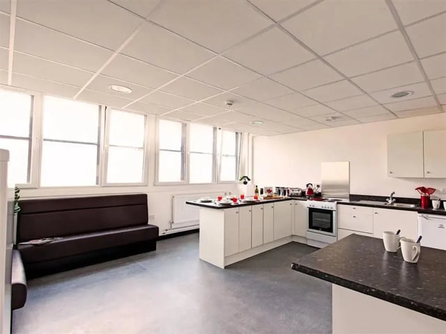 Brown sofa kitchen counter appliances and cups kitchen at MyPad Paisley in Paisley Student Accommodation