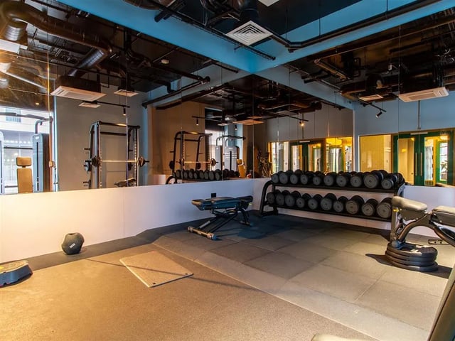 Dumbbells weight bench gym equipment fitness room at Calico in Liverpool Student Accommodation
