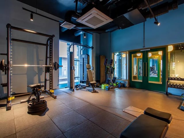 Weight rack bench barbells and dumbbells gym at Calico in Liverpool Student Accommodation