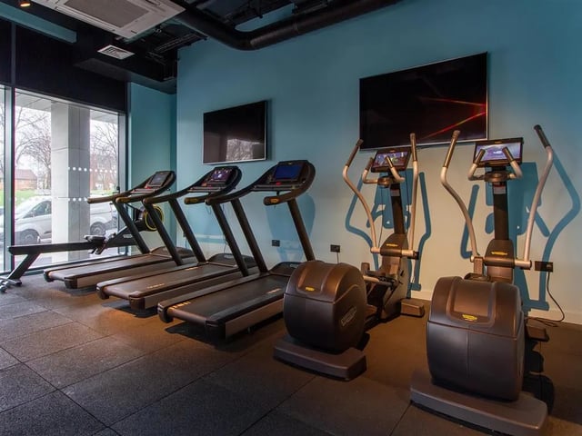 Gym with treadmills elliptical machines and televisions gym at Calico in Liverpool Student Accommodation