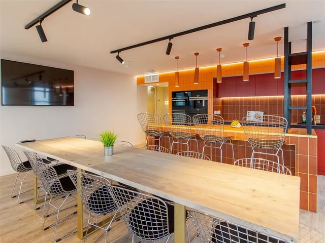 Large wooden table wire chairs modern kitchen living room at Calico in Liverpool Student Accommodation