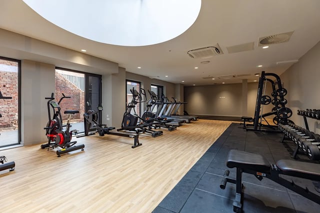 Treadmills rowers weights gym equipment playing area at Benson Yard in Liverpool Student Accommodation