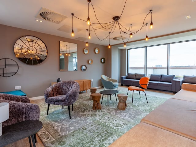 Sofas armchairs coffee tables large rug living room at Benson Yard in Liverpool Student Accommodation