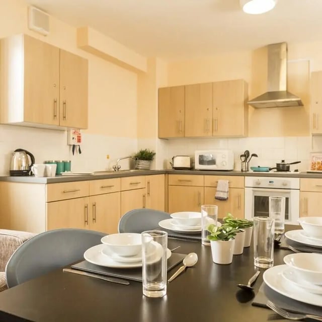 Kitchen with dining table and place settings kitchen at Okeford House in Bournemouth Student Accommodation