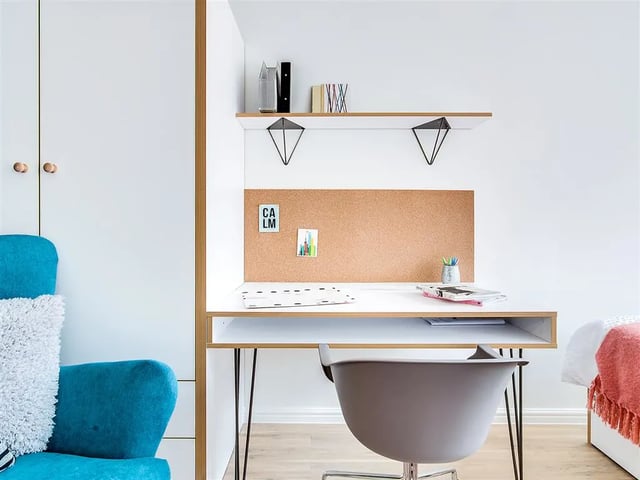 Desk with corkboard chair and books study area at New Orient House in London Student Accommodation