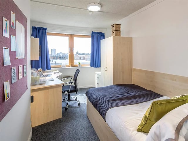 Bed desk chair wardrobe student accommodation bedroom at New Orient House in London Student Accommodation
