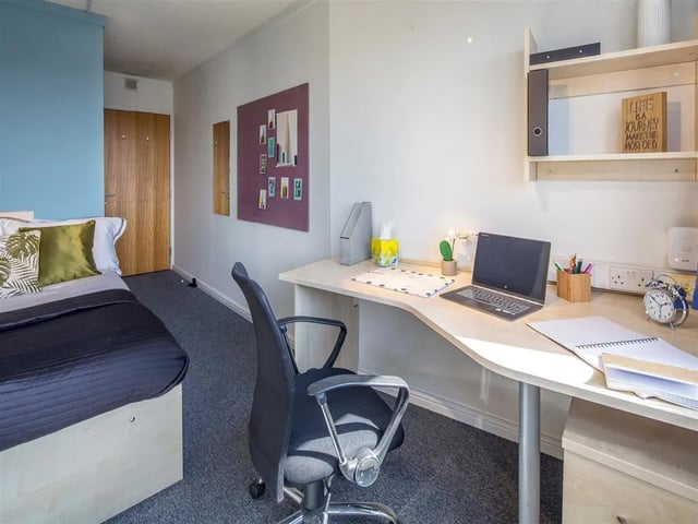 Bed desk laptop alarm clock study area at New Orient House in London Student Accommodation