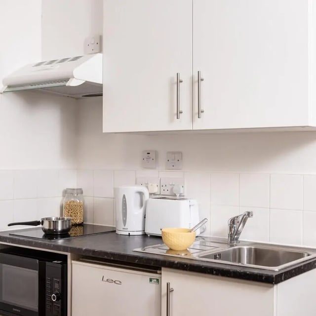 Countertop with microwave kettle toaster sink kitchen at Prince Consort Village in London Student Accommodation