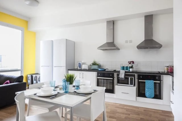 Modern kitchen with dining table and sofa kitchen at Prince Consort Village in London Student Accommodation