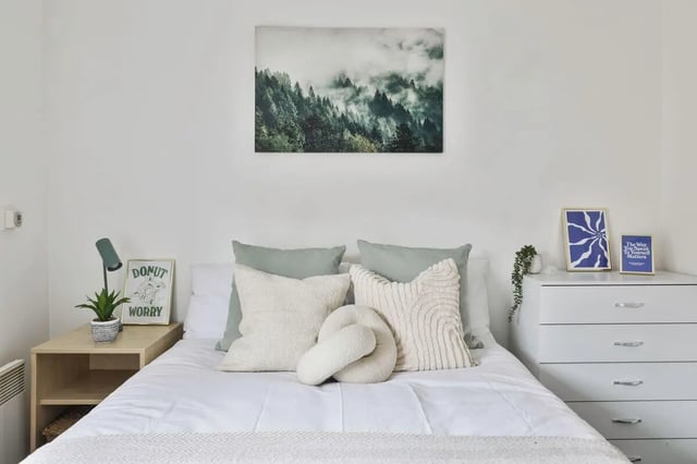Bed with pillows art and dresser bedroom at Pavilion Court in Canterbury Student Accommodation