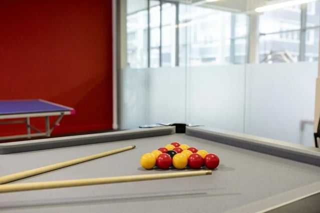Pool table with racked balls and cues playing area at Fitzroy Court in Luton Student Accommodation