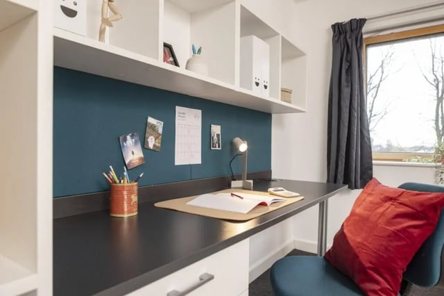Desk with lamp books and chair study area at Fitzroy Court in Luton Student Accommodation