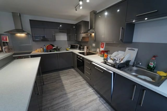 Modern grey cabinets sink dishes stove kitchen at Middle Street - Nottingham in Nottingham Student Accommodation