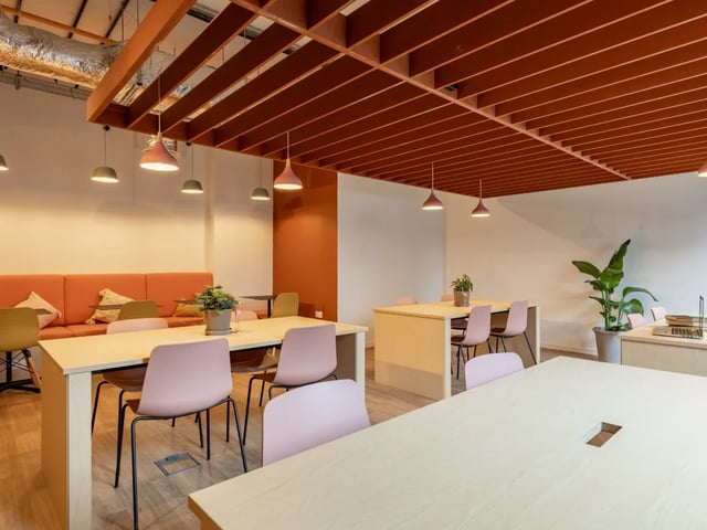 Orange sofa pink chairs tables communal area at The Waterways Nottingham in Nottingham Student Accommodation