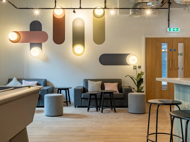 Pool table sofas stools and wall lights communal area at The Waterways Nottingham in Nottingham Student Accommodation