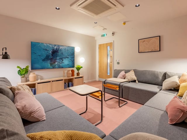 Large grey sectional sofa with TV living room at The Waterways Nottingham in Nottingham Student Accommodation