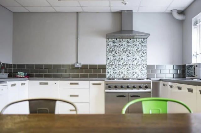 White cabinets stove microwave patterned backsplash kitchen at John Lester and Eddie Colman Courts in Salford Student Accommodation