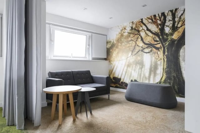 Sofa tables bench with forest mural living room at John Lester and Eddie Colman Courts in Salford Student Accommodation