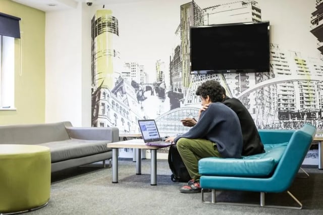 Two students with laptop on sofas Living room at John Lester and Eddie Colman Courts in Salford Student Accommodation