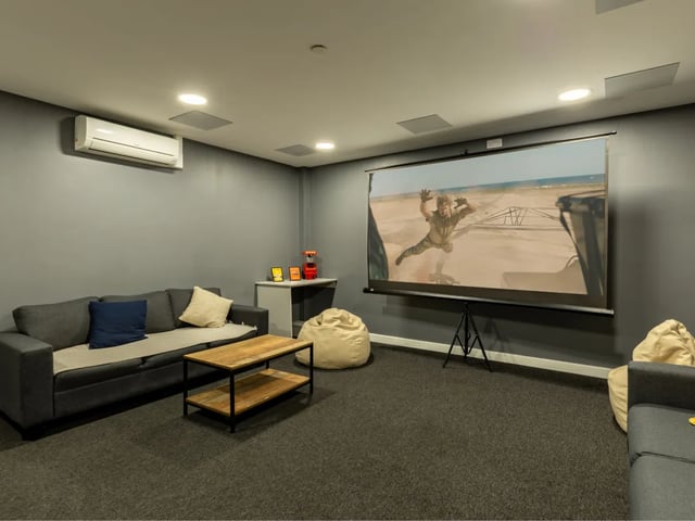 Sofa projector screen beanbags and coffee table living room at Radford Mill in Nottingham Student Accommodation