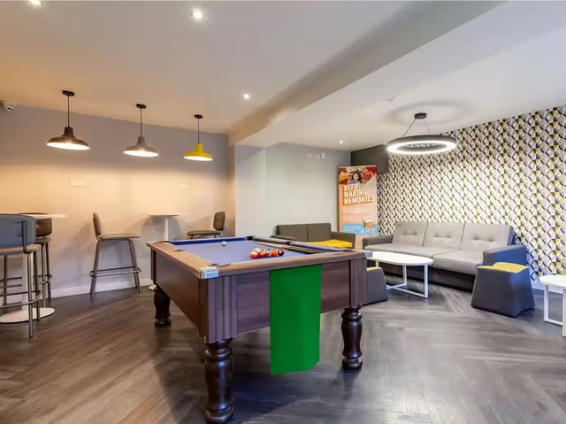 Pool table couches modern light fixture communal living room at Allen Court in Manchester Student Accommodation