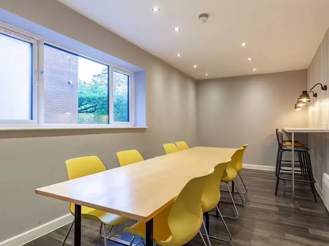 Long table yellow chairs bar area lounge area at Allen Court in Manchester Student Accommodation