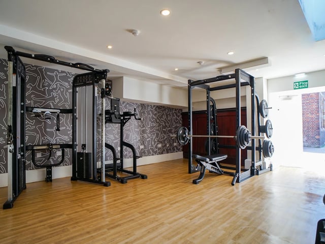 Weight machines and barbell rack gym area at Orme House in Newcastle Under Lyme Student Accommodation