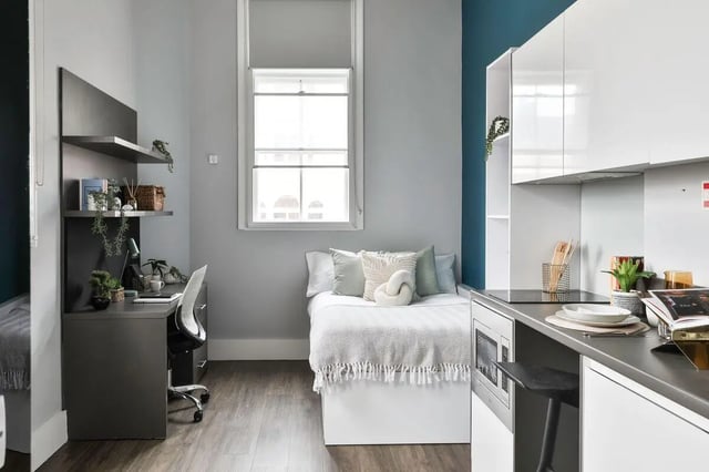 Bed desk shelves and kitchenette student studio at The Hahnemann Building in Liverpool Student Accommodation