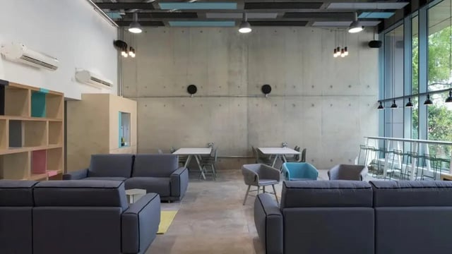 Sofas tables chairs shelving lounge area at Lace Market Studios in Nottingham Student Accommodation