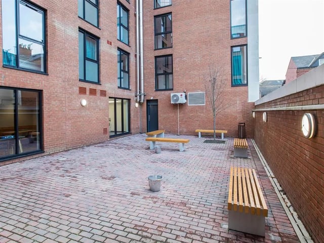 Brick courtyard with benches and windows exterior at Botanic Studios in Belfast Student Accommodation