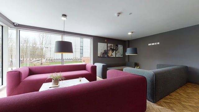 Modern sofas artwork and large windows communal living room at One London Road in Newcastle Under Lyme Student Accommodation