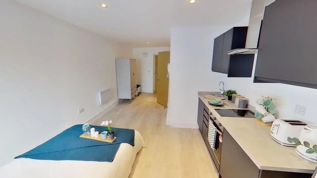 Bed kitchen wardrobe and hallway studio apartment at Dojo House Nottingham in Nottingham Student Accommodation