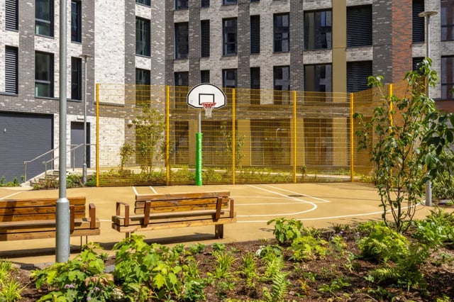 Basketball court with benches and foliage exterior at Winfield Court in Nottingham Student Accommodation