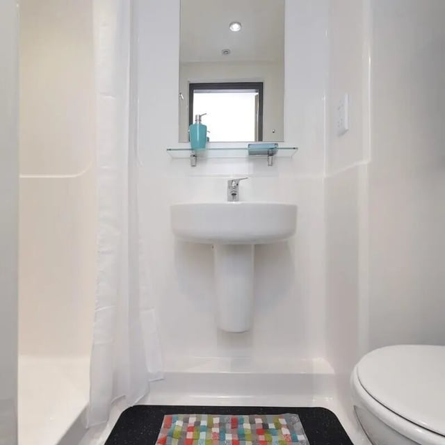 Sink mirror shower stall and toilet bathroom at Peel Park Quarter in Salford Student Accommodation
