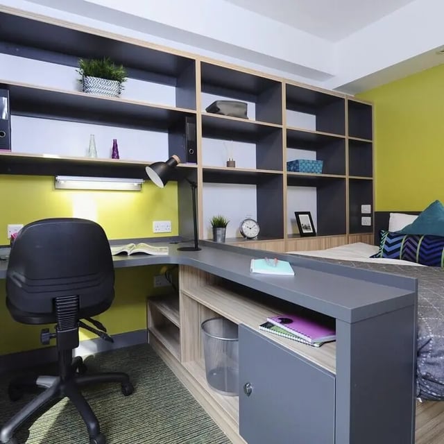 Desk chair lamp shelves and bed study area at Peel Park Quarter in Salford Student Accommodation