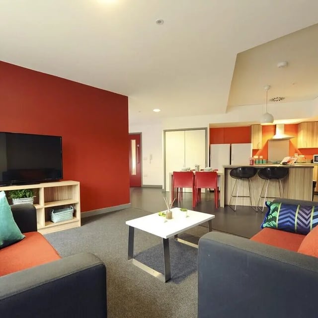 Sofa TV kitchen island dining table living room at Peel Park Quarter in Salford Student Accommodation