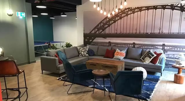 Sectional sofa with bridge mural and ping pong table living room at Barker House in Newcastle Upon Tyne Student Accommodation