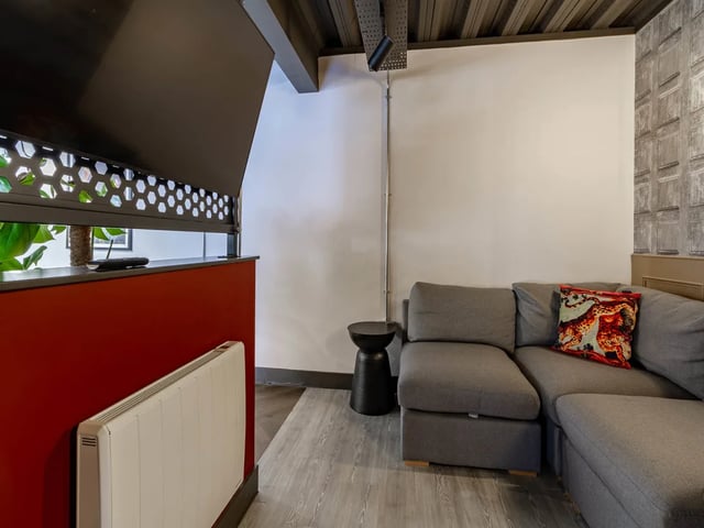 Grey sectional sofa with patterned cushion living room at Truro Sheffield in Sheffield Student Accommodation