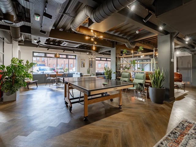 Ping pong table chairs plants living room at Truro Sheffield in Sheffield Student Accommodation