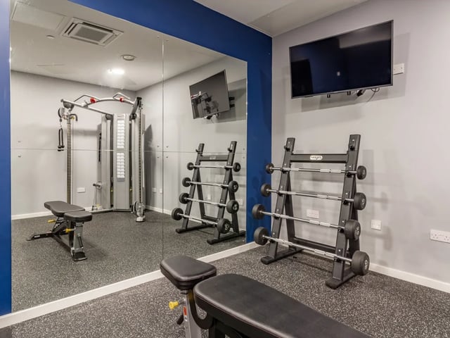 Weights bench cable machine rack dumbbells gym area at The Gate in Sheffield Student Accommodation