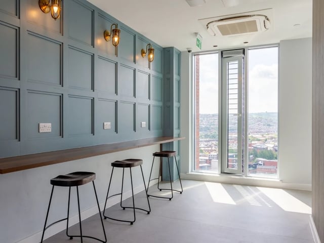 Bar seating with wall accents and window view communal area at The Gate in Sheffield Student Accommodation