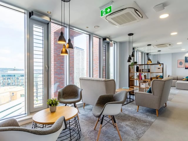 Chairs table bookshelf seating lounge living room at The Gate in Sheffield Student Accommodation
