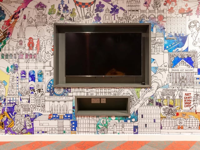 Wall mural with TV entertainment area living room at The Gate in Sheffield Student Accommodation