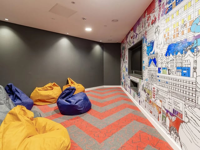 Beanbags and TV on mural wall lounge area at The Gate in Sheffield Student Accommodation