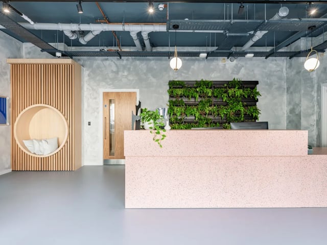 Reception desk with plants and seating area interior at Ty Nant in Swansea Student Accommodation
